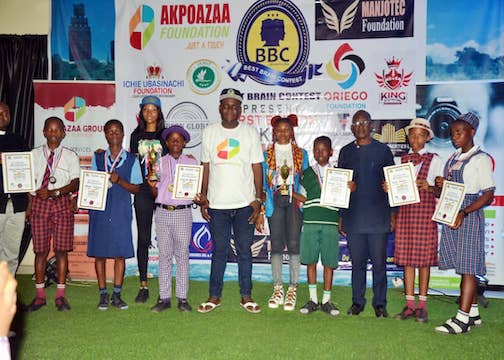 CEO of Akpoazaa Group Frank Igbojindu in a group picture with the winners of Okija Mathematics and Igbo Quiz Competition