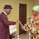 The Chairman of the NDDC Governing Board, Mrs. Lauretta Onochie, (right) Receiving documents from the PHCCIMA President, Eze Mike Elechi, (left) during a courtesy visit at the NDDC headquarters