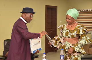 The Chairman of the NDDC Governing Board, Mrs. Lauretta Onochie, (right) Receiving documents from the PHCCIMA President, Eze Mike Elechi, (left) during a courtesy visit at the NDDC headquarters