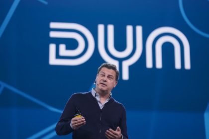 Christian Seifert, founder and shareholder of sports streaming service Dyn, stands in front of the company logo on stage at the OMR digital trade show in the exhibition halls. Photo: Marcus Brandt/dpa