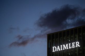 The Daimler AG logo can be seen on a facade of the company's headquarters. Photo: Marijan Murat/dpa