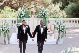 Nigerian gay couple, Tosin and Andrew holding hands from the alter, after the marriage