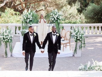 Nigerian gay couple, Tosin and Andrew holding hands from the alter, after the marriage