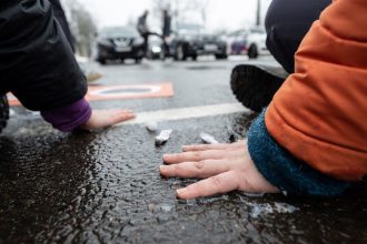 Using superglue, two activists of the Last Generation have stuck themselves to the roadway of Jahnallee in Leipzig. Three quarters of the participants in a recent survey conducted by pollsters YouGov in Germany on behalf of dpa rejected efforts by climate group Last Generation to force more action on climate change with tactics such as street blockades. Photo: Hendrik Schmidt/dpa
