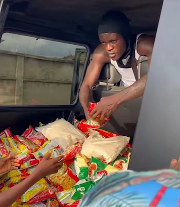 Azeez Okikiola better known as Portable distributes food items with his G Wagon