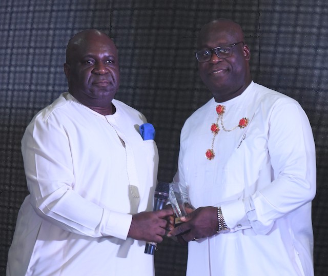 The NDDC Director, Health and Social Services, Dr. George Uzonwanne, (right) representing the NDDC Managing Director, Dr. Samuel Ogbuku, receiving the “Heart of Gold Award” from Chairman/CEO of DKL Development Ltd, Mr. Kio Lawson, (left) during the 13th Edition of the Eveafrique Redball event in Port Harcourt.