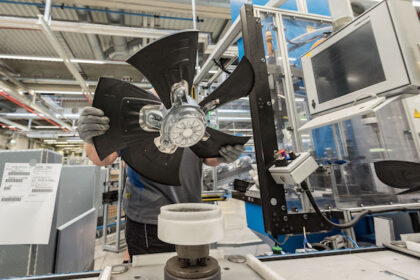 An employee of ebm-papst, a manufacturer of fans and electric motors, assembles a fan in Hollenbach. Photo: Daniel Maurer/dpa