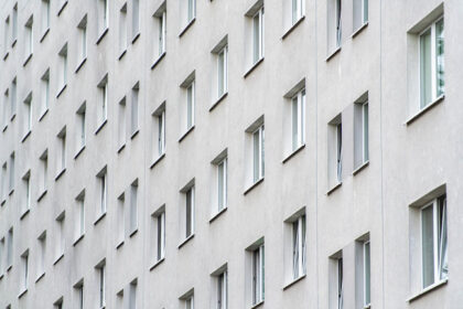 View on a grey house facade with many windows. Photo: Christophe Gateau/dpa