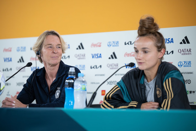 Martina Voss-Tecklenburg (L), coach of the German women's national soccer team, and Germany's Lina Magull speak at a press conference during the FIFA Women's World Cup 2023, at Sydney Football Stadium. Photo: Sebastian Christoph Gollnow/dpa