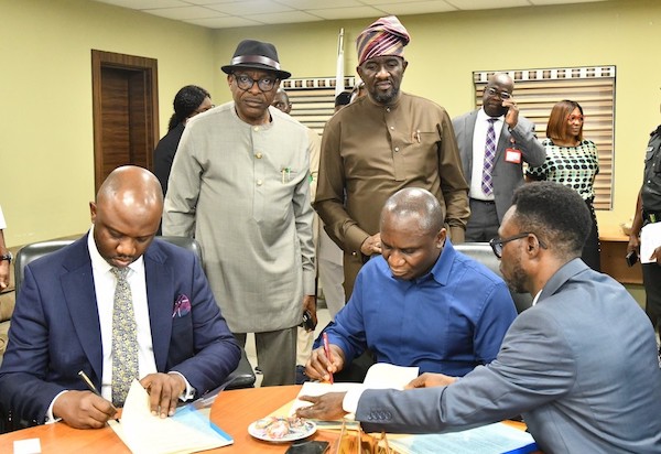 The Lead Partner and Head, Governance Processes, KPMG, Mr. Tolu Odukale (left) and the NDDC Managing Director, Dr. Samuel Ogbuku, signing agreement at the NDDC headquarters in Port Harcourt. Behind them are NDDC Executive Director Finance and Administration, Major General Charles Airhiavbere (Rtd) and Executive Director, Projects, Mr. Charles Ogunmola.