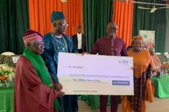 From Right: Managing Director/CEO of Unity Bank Plc, Mrs Oluwatomi Somefun; Regional Manager, Unity Bank, Mr Segun Olarenwaju presenting cheque to the Onifiditi of Fiditi, Oba Sakiru Oyewole Adekola-Oyelere, Ajani-Eedu II and the Chairman of the Committee, Professor John Oluokun during the during the official launch and Groundbreaking of National Open University of Nigeria, Fiditi Study Centre on Saturday at Fiditi Grammar School, Oyo state