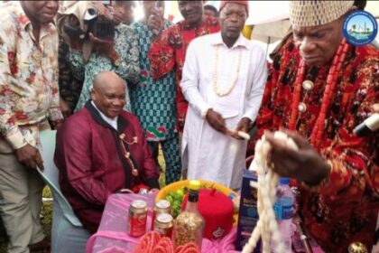 The Representative of Abia State on the NDDC Governing Board, Chief Eruba Dimgba (sitting), receiving a chieftaincy title from the Chairman of Ukwa West Traditional Rulers Council, Eze Chinyere Dike during a reception organised in his honour by the people of Asa community at the Ogwe Central School, Asa.