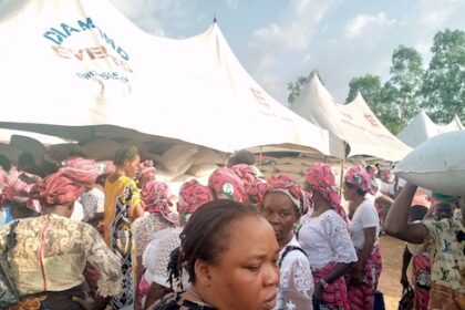 Some of the widows during the distribution of houses and bags off rice