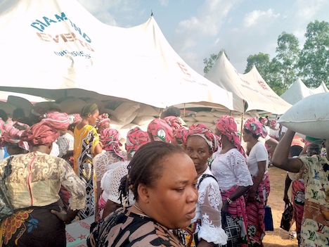 Some of the widows during the distribution of houses and bags off rice