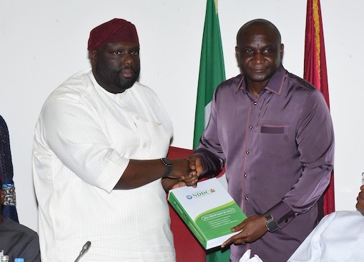 The NDDC Managing Director, Dr Samuel Ogbuku (right), presenting the 2024 budget proposal to the Chairman of the Senate Committee on NDDC, Senator Asuquo Ekpeyong (left), at the National Assembly.